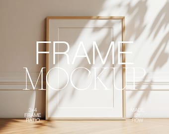 May include: A wooden frame mockup with a 3x4 frame ratio. The frame is sitting on a wooden floor with a white wall and a shadow behind it. The text "FRAME MOCKUP" is written in white on the wall. The text "3x4 FRAME RATIO" is written in white on the floor below the frame. The text "MADE BY ROW" is written in white on the floor to the right of the frame.