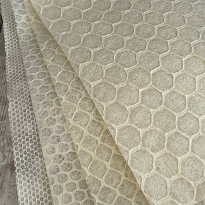 May include: Four sheets of white textured paper with a honeycomb pattern. The paper is translucent and has a slightly rough texture.
