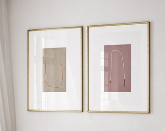 May include: A white bed with a black and white patterned throw blanket and a white pillow with a black and white geometric pattern. A white chair with wooden legs is in the corner of the room. Two framed abstract art prints with gold frames hang on the wall.
