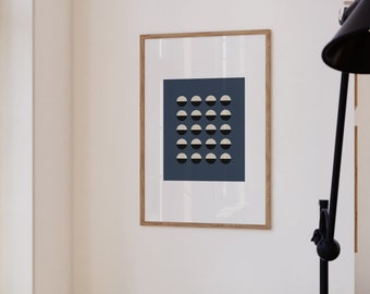 May include: A framed print of a geometric design featuring a grid of 20 white and black half circles on a dark blue background.