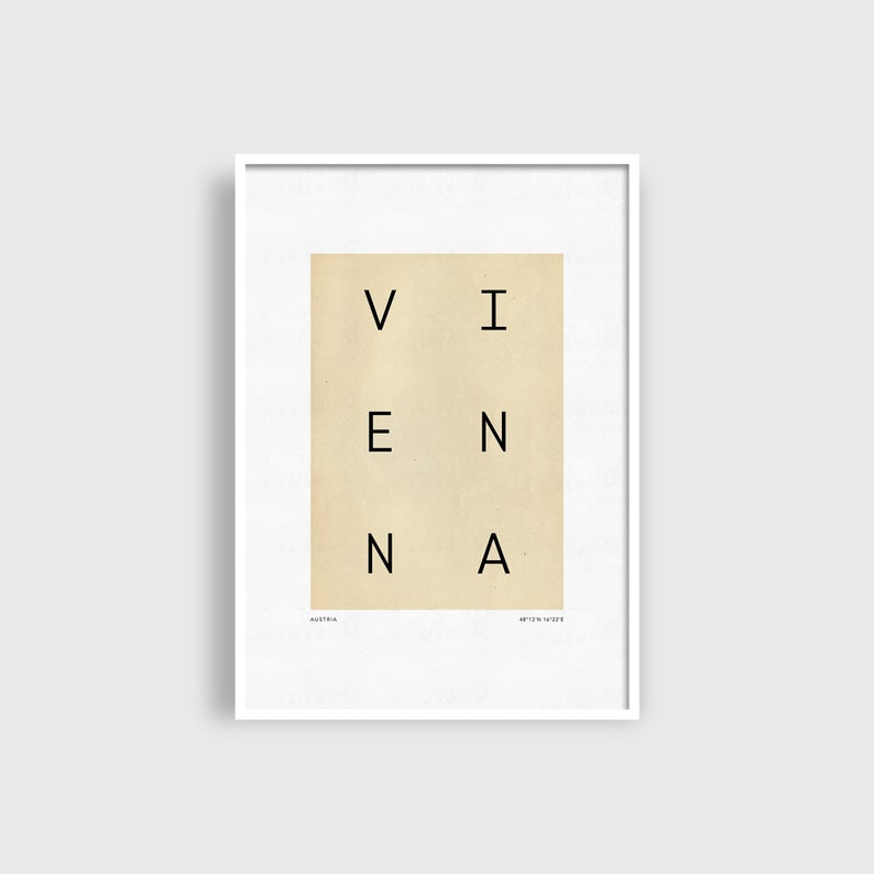 May include: A white framed print with a beige background and the word "VIENNA" spelled out in black letters.