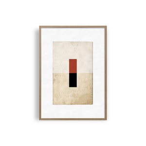 Op de afbeelding: Een ingelijste abstracte kunstprint met een rood en zwart geometrisch ontwerp op een beige achtergrond.