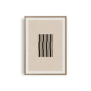May include: A framed print featuring a black and white geometric pattern on a beige background.