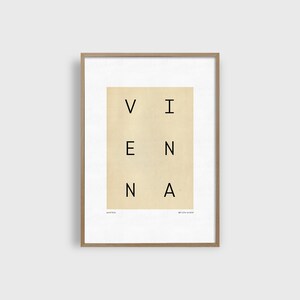 May include: A framed print with the word "VIENNA" spelled out in a grid pattern on a beige background. The text "AUSTRIA" appears at the bottom left and "ART PRINT 14x18" appears at the bottom right.