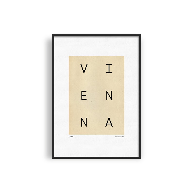 May include: A black framed print with a beige background and the word "VIENNA" spelled out in black letters. The words "AUSTRIA" and "ART PRINT 12x16" are printed in smaller font at the bottom of the print.