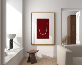 May include: A white living room with a red framed artwork featuring a gold line, a wooden stool, and a white couch.
