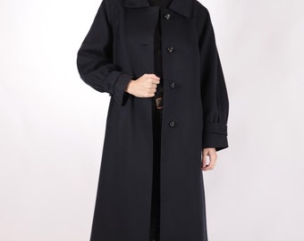 May include: A long, navy blue coat with a button closure and long sleeves. The coat has a classic, tailored look and is made of a soft, luxurious fabric.