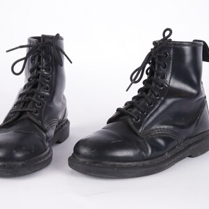 May include: A pair of black leather lace-up boots with a thick sole.