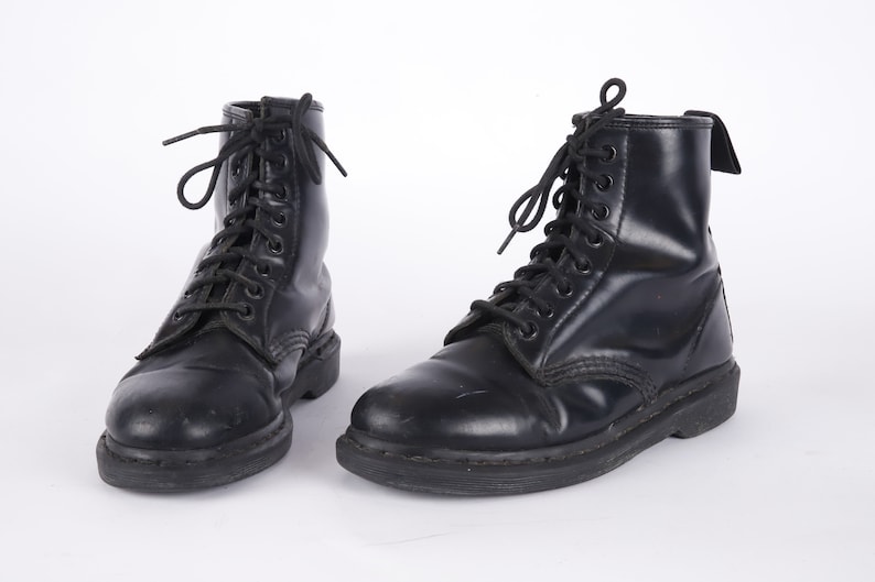 May include: A pair of black leather lace-up boots with a thick sole.