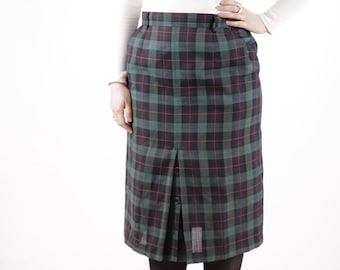 May include: A green, black, and red plaid skirt with a button closure. The skirt is knee-length and has a straight silhouette.