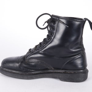 May include: A pair of black leather lace-up boots with a thick sole.