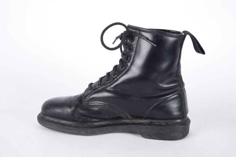 May include: A pair of black leather lace-up boots with a thick sole.