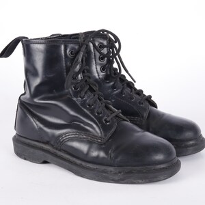 May include: A pair of black leather lace-up boots with a thick sole.