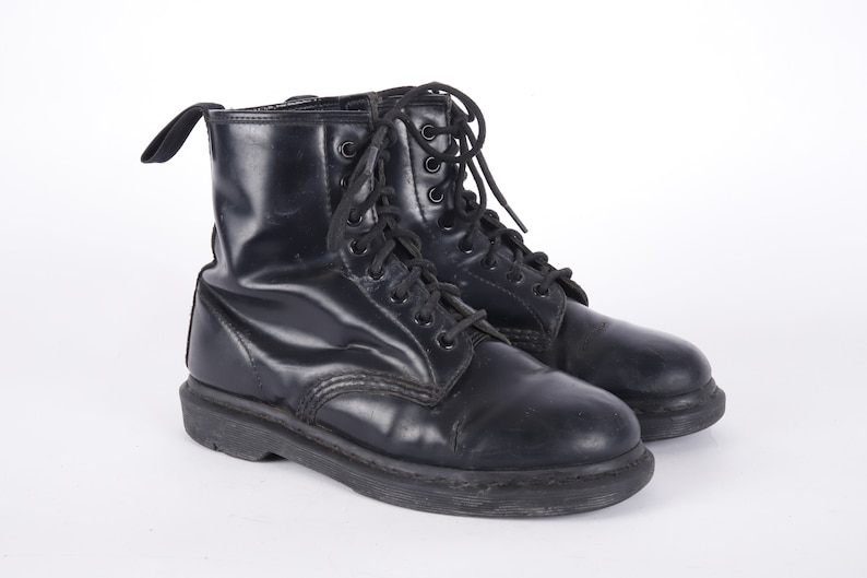 May include: A pair of black leather lace-up boots with a thick sole.
