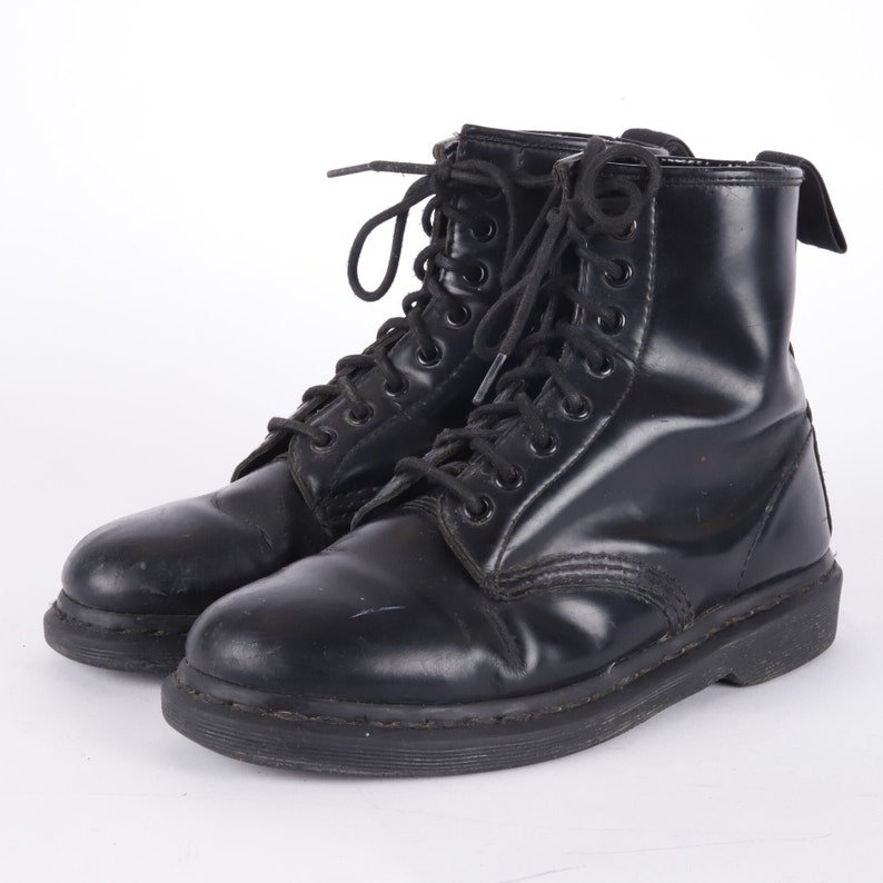 May include: Black leather lace-up boots with a thick black sole.