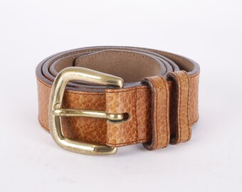 May include: A brown leather belt with a gold buckle. The belt is made of a textured leather and has a double layer of leather.
