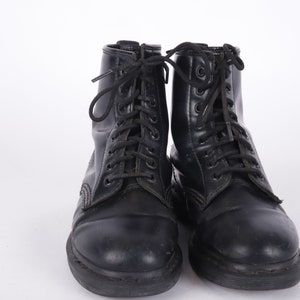 May include: A pair of black leather lace-up boots with a thick sole.
