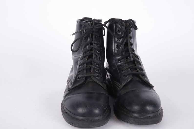 May include: A pair of black leather lace-up boots with a thick sole.