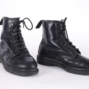 May include: A pair of black leather lace-up boots with a thick sole.