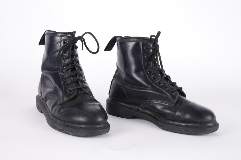 May include: A pair of black leather lace-up boots with a thick sole.