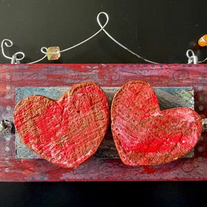 May include: A rustic wooden sign with the text "Welcome to our home" in white lettering. The sign features a distressed finish and a simple, inviting design, perfect for entryway decor.