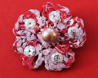 Unique flower brooch handmade from recycled plastic bags. Durable striking red design with silver sequins. Quirky, unusual, crochet, corsage