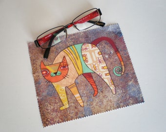 May include: A colorful cat illustration on a brown microfiber cleaning cloth. The cat has a green, orange, and yellow patterned body with a red tail.