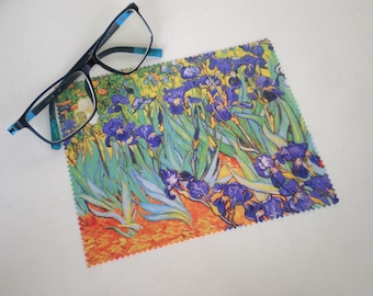 May include: A microfiber cleaning cloth with a colorful print of a painting of purple iris flowers with green leaves and a yellow background.