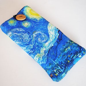 May include: A blue and yellow fabric eyeglass case with a wooden button closure. The case features a print of Vincent van Gogh's "The Starry Night" painting.