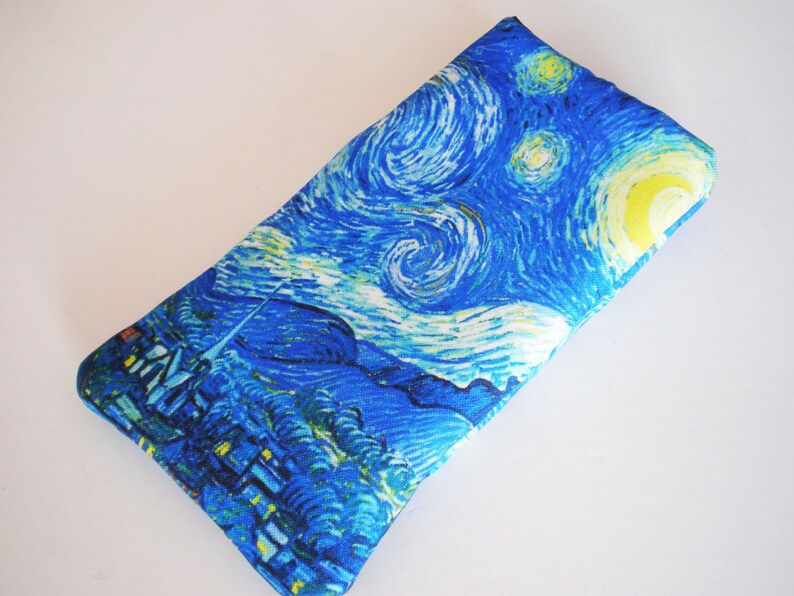 May include: A blue and yellow fabric pouch with a print of Vincent van Gogh's "Starry Night" painting.