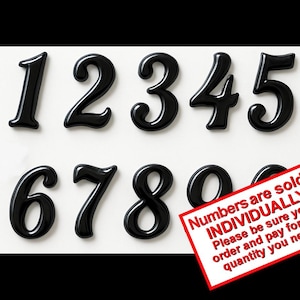 May include: A set of glossy black, three-dimensional numbers from one to zero arranged in two rows on a white background. A red-bordered rectangular sign is overlaid on the bottom right, containing the text: Numbers are sold INDIVIDUALLY. Please be sure you order and pay for the quantity you need.