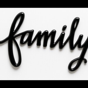May include: A glossy black "family" word art sign in a cursive font. The word is centered on a white background. The sign is a decorative item, suitable for home decor.