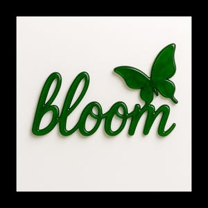 May include: A glossy green word "bloom" in a cursive font, with a green butterfly to the right. The word and butterfly are set against a white background.