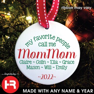May include: A white ceramic Christmas ornament with a red and white ribbon. The ornament reads "my favorite people call me MomMom" with names and the year 2022. The text "MADE WITH ANY NAME & YEAR" is at the bottom.