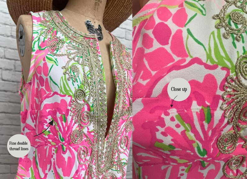 May include: A sleeveless dress featuring a white base with a vibrant pink and green floral pattern. The neckline and front placket are adorned with intricate gold metallic embroidery. The garment includes fine double thread lines as shown.