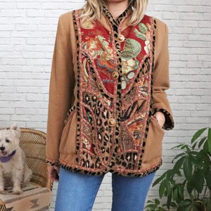 May include: A brown jacket with a colourful patchwork design featuring floral, animal print, and geometric patterns. The jacket has a button closure and pockets.