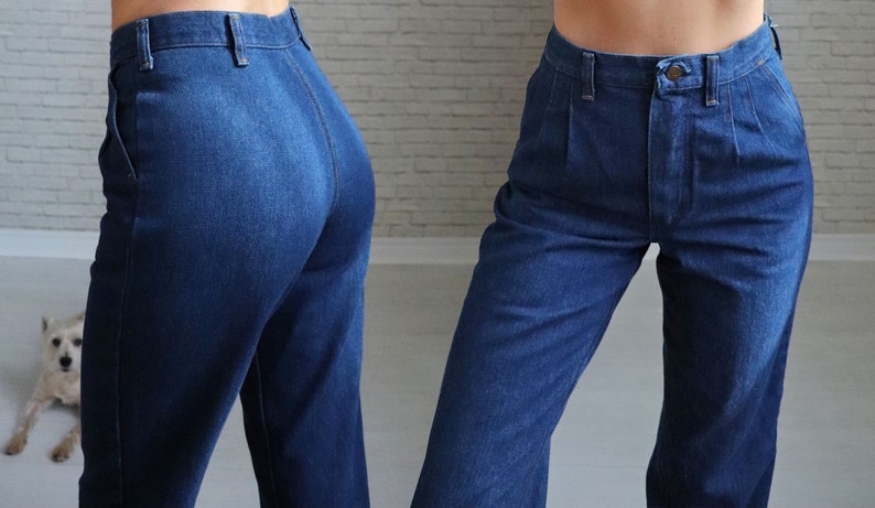 May include: A pair of high-waisted, blue denim jeans with a straight leg fit. The jeans have a button fly and belt loops.
