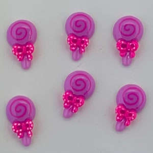 May include: Six purple lollipop charms with pink bows and white polka dots. The lollipops have a pink swirl design.