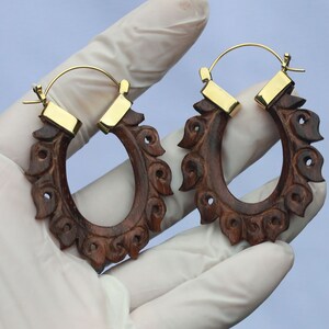 bali carving style earrings ,   wood and brass combinations with brass post .  hand made .price per pair