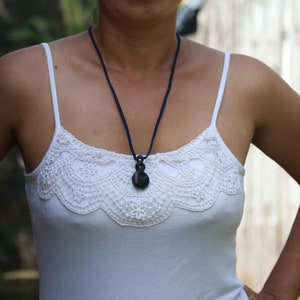Triple Twist Eternity Pendant ,black arang wood with hand woven adjustable nylon thread band. Adjustable