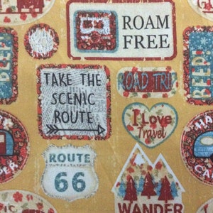 May include: A yellow fabric with a repeating pattern of vintage-style travel themed patches. The patches feature images of campers, arrows, and text such as "Take the Scenic Route", "Road Trip", "Roam Free", "Route 66", and "I Love Travel".