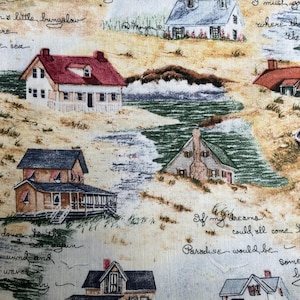 May include: A fabric print featuring a coastal scene with several houses, each with a unique design and color scheme. The houses are set against a backdrop of sand and water, with handwritten script adding a whimsical touch. The overall theme is a seaside village.