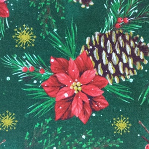 May include: A green fabric with a repeating pattern of red poinsettias, pine cones, pine branches, and gold snowflakes.