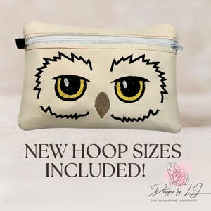 May include: A cream-colored rectangular zippered pouch featuring an embroidered owl face with large yellow eyes and a brown beak. The text below reads NEW HOOP SIZES INCLUDED! along with a butterfly logo and the text Designs by LJ DIGITAL MACHINE EMBROIDERY.