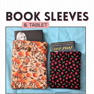 May include: Two fabric book sleeves with books inside. One sleeve features a peach and butterfly pattern, the other has a black background with red roses. The text "BOOK SLEEVES & TABLET" is at the top.