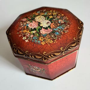 Vintage red tin chocolates/biscuit box with flowers design. Floral metal box made in England. 5'' wide. Please see description.