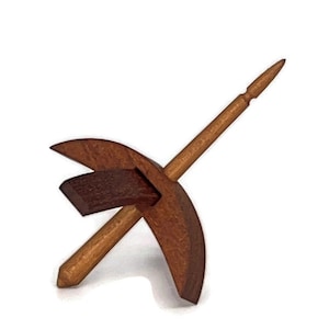 May include: A wooden spinning wheel with a brown spindle and a crescent-shaped base.