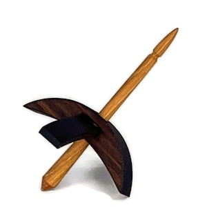 May include: A wooden spinning wheel with a dark wood base and a light wood spindle.