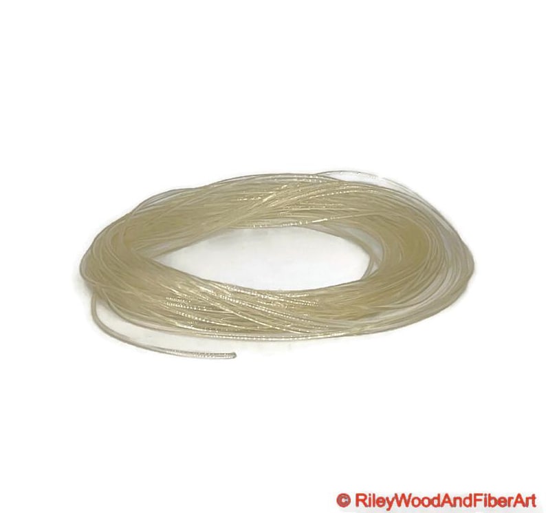 three thirty seconds clear polyurethane drive band material. It is a 100-foot roll coiled up forming kind of a large clear donut made of spaghetti.