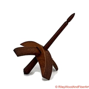 May include: A wooden spinning wheel with a brown spindle and a dark brown base. The base is shaped like a crescent moon.